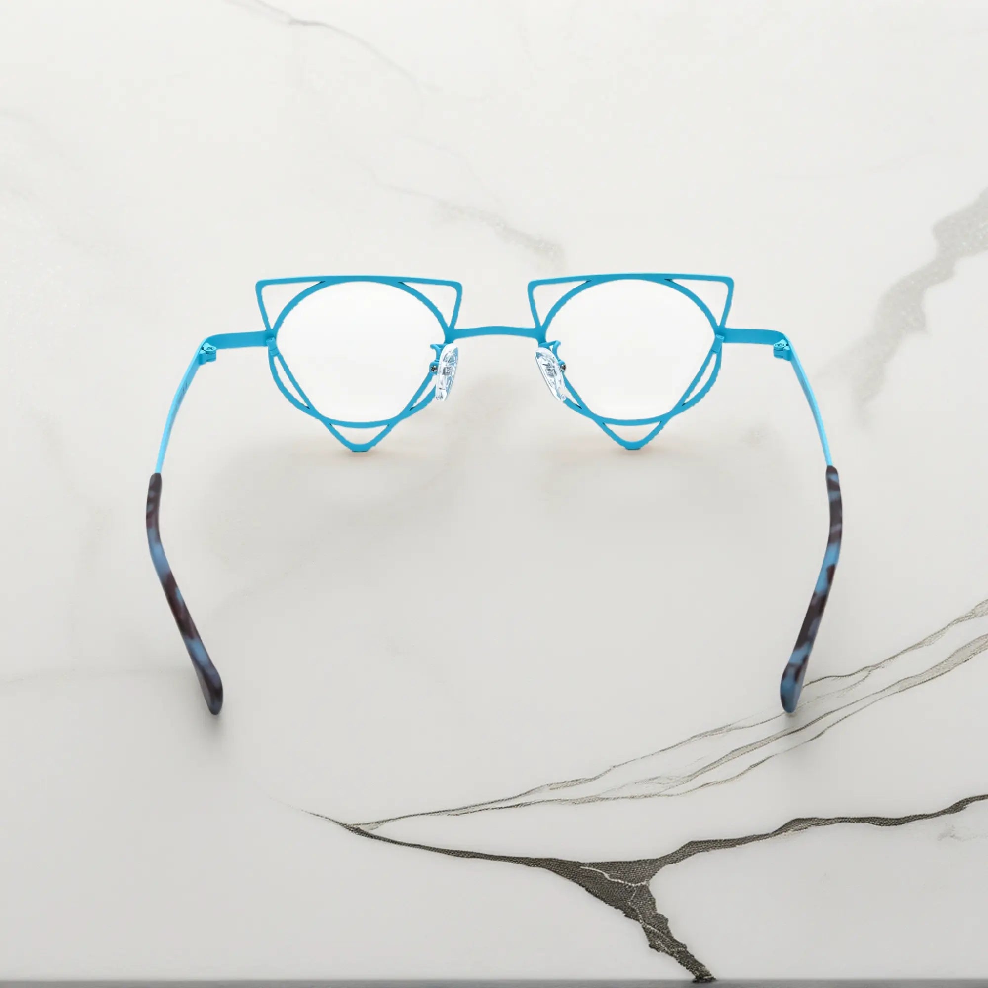 Back angle revealing artistic frame curves of VoyueLens™ Tangerine Blue geometric glasses, crafted from lightweight titanium